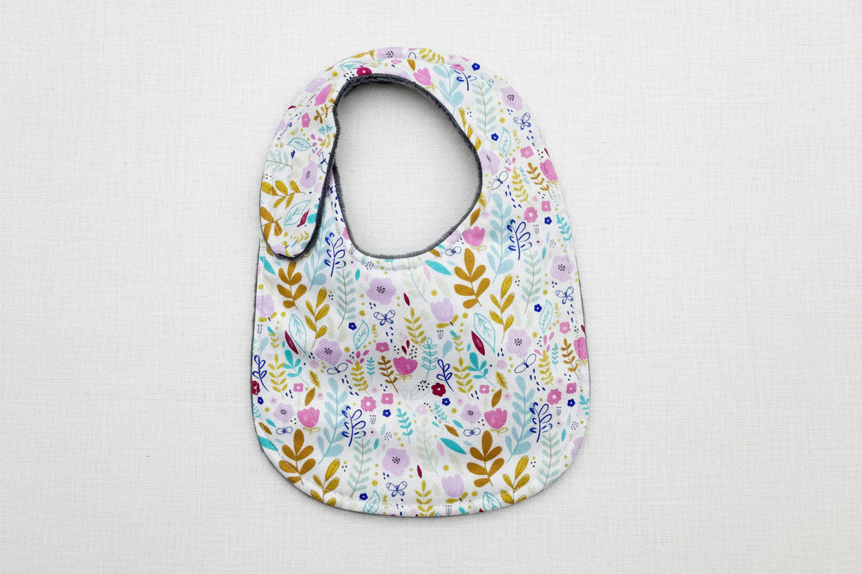 Floral patterned baby bib on a white background