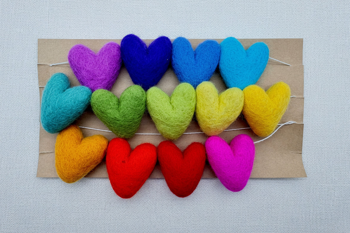 Colorful heart-shaped garland on a cardboard base