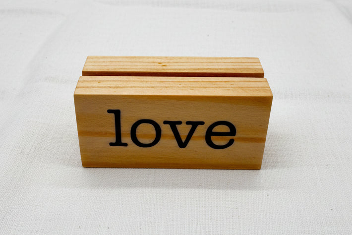 Wooden picture block with 'love' engraved on it