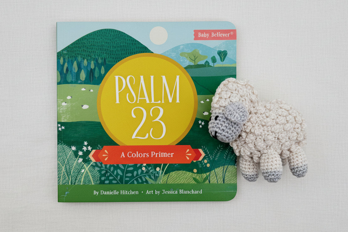 Children's book titled 'Psalm 23' with a crocheted sheep toy