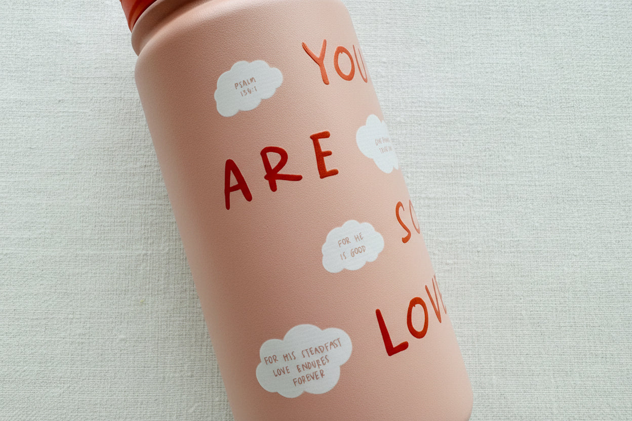 Pink water bottle with scripture text and cloud graphics