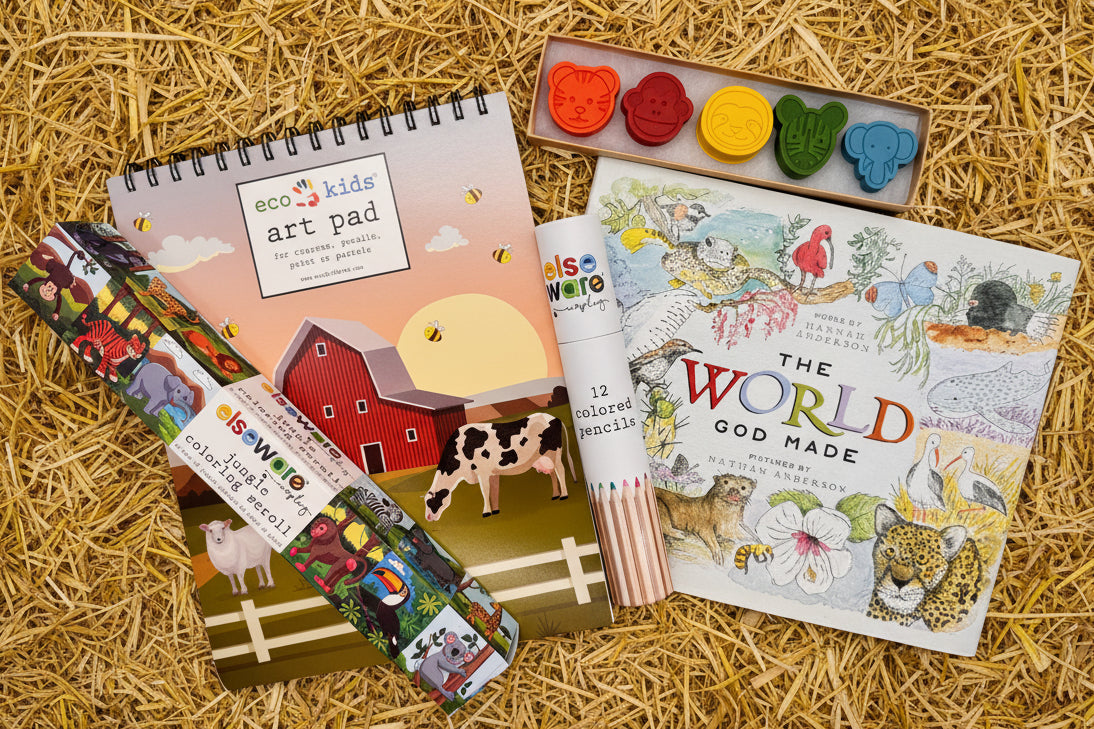 Children's book "The World God Made" and collection of art supplies including animal shaped crayons and an art pad