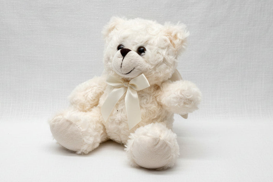 White angel teddy bear with a bow 
