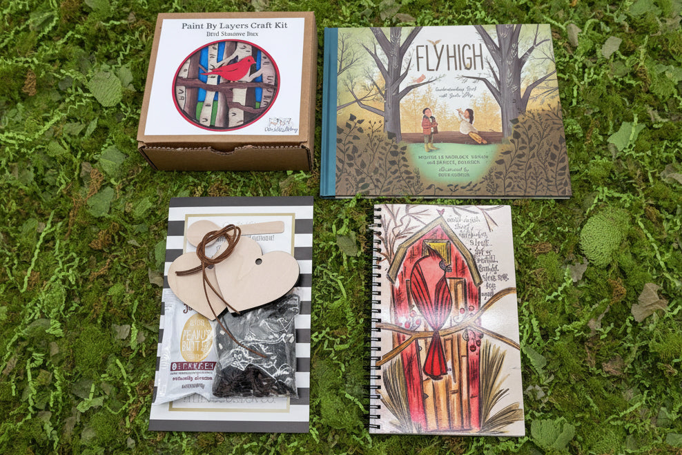 Collection of books and craft kits on a grassy background