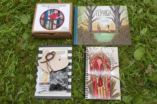 Load image 1 in gallery view. Collection of books and craft kits on a grassy background