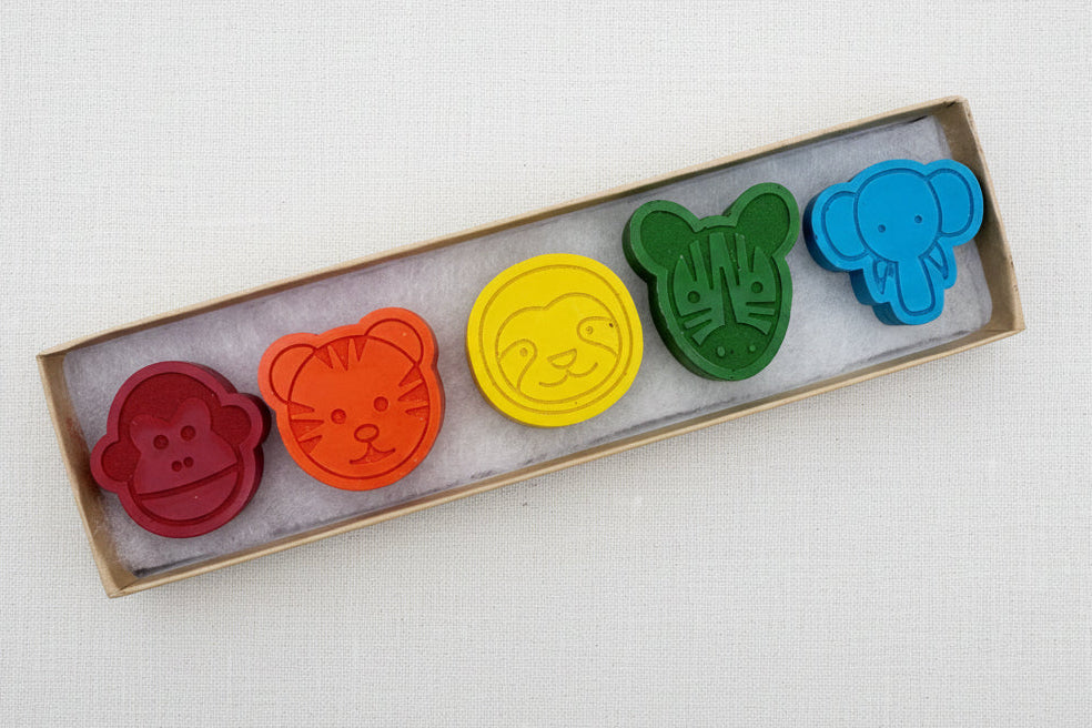 Set of colorful animal-shaped crayons in a box 