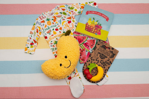 Load image 1 in gallery view. Infant items, including banana plush toy, fruit-shaped teether, and book 