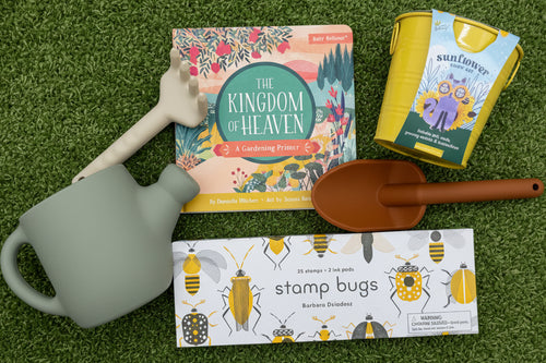 Load image 1 in gallery view. Gardening-themed items including a book, flower growing kit, stamp set and toy gardening tools on a green background