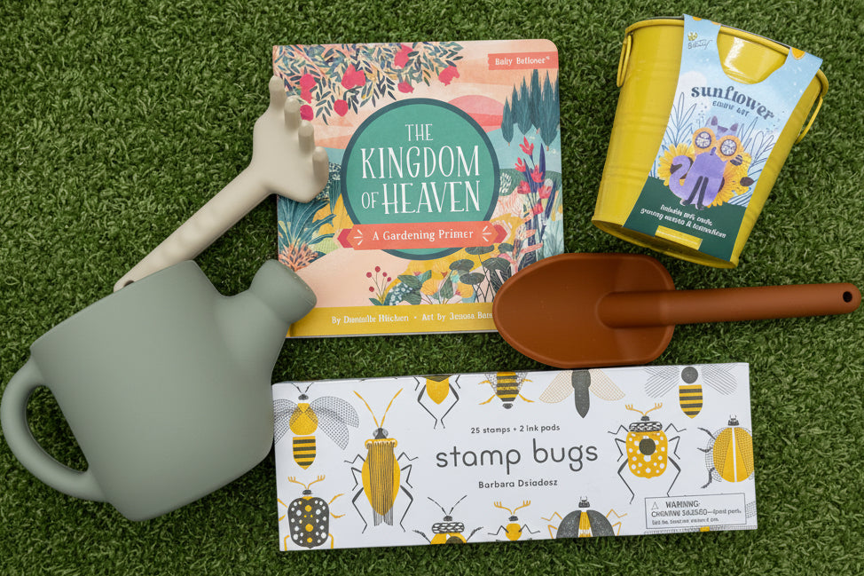 Gardening-themed items including a book, flower growing kit, stamp set and toy gardening tools on a green background