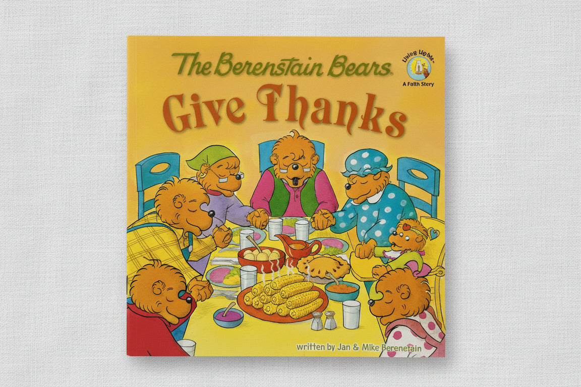 The Berenstain Bears "Give Thanks" children's book, featuring a bright yellow cover with an illustration of the bear family gathered around a table with food and thanksgiving themes.