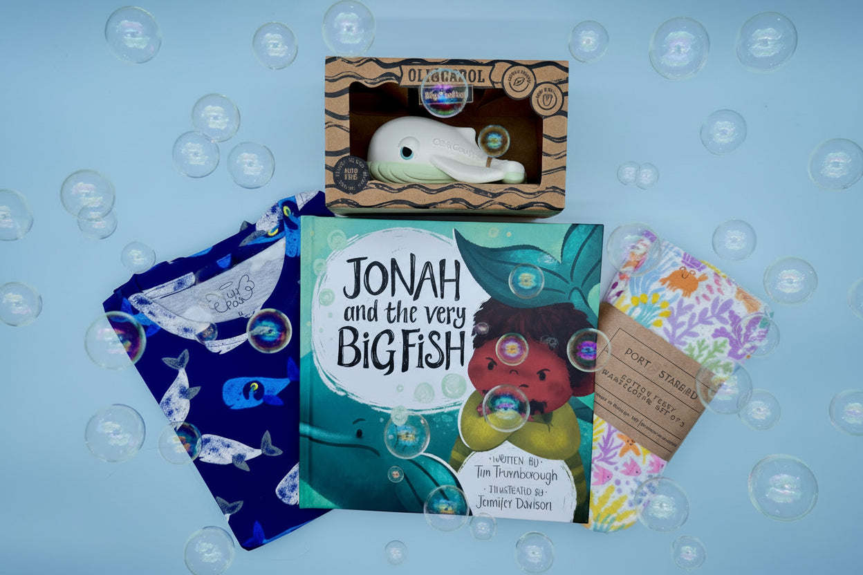Children's book titled 'Jonah and the Very Big Fish' with pajamas, washcloth, and whale bath toy