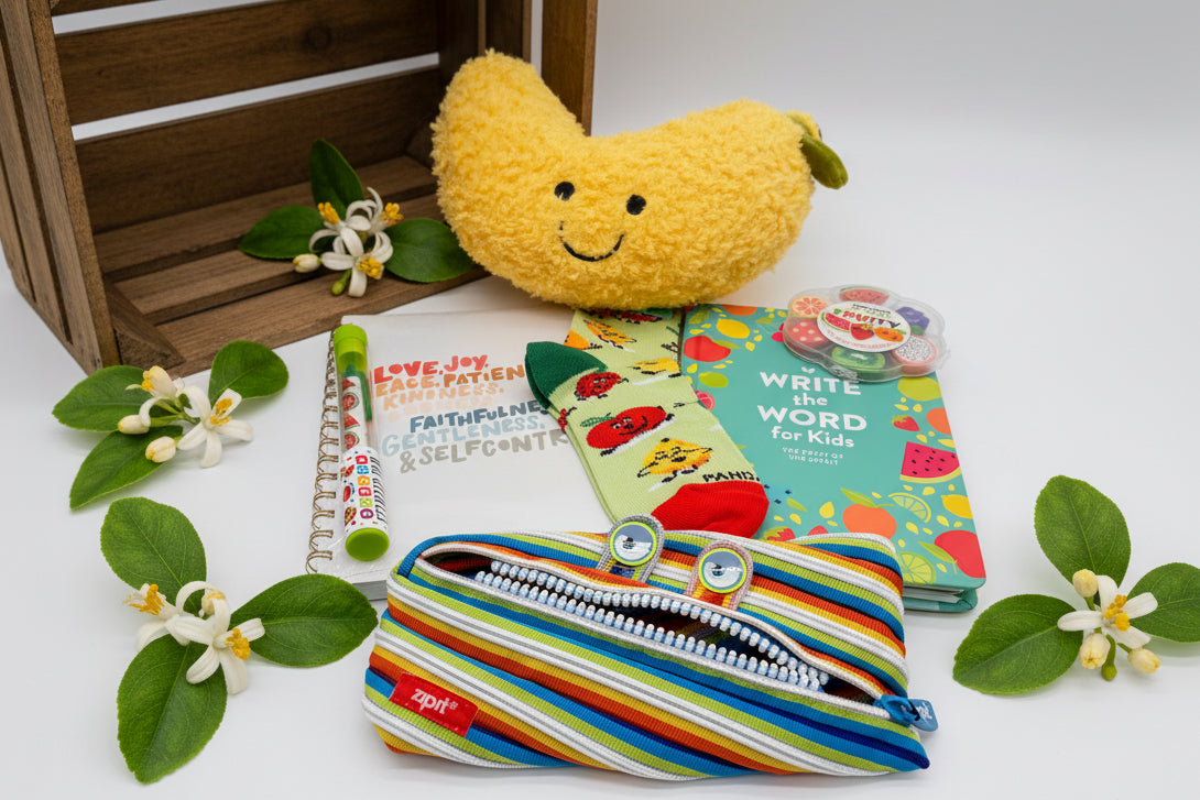 Colorful children's items including a plush banana toy, book, journal, socks and a pencil pouch 