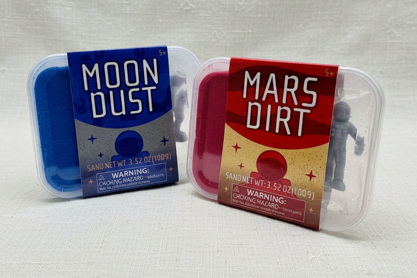 Two containers labeled 'Moon Dust' and 'Mars Dirt' each containing colorful sand and figurine