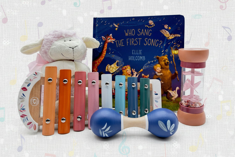 Children's musical instruments, stuffed pink lamb, and a book 