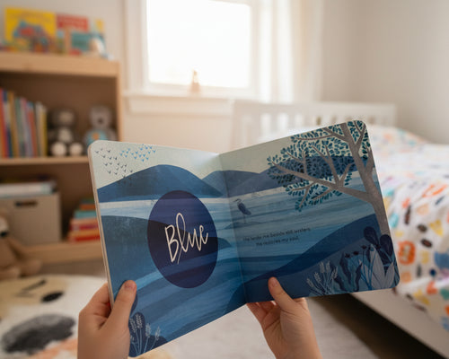 Load image 1 in gallery view. Children's book featuring a nature scene and the word 'Blue' and a Bible scripture  with child's bedroom in background
