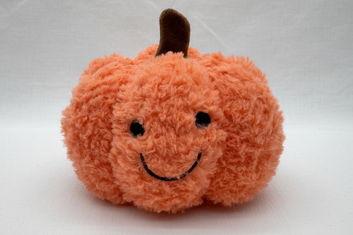 Load image 1 in gallery view. An orange fuzzy plush pumpkin toy with a dark brown stem and a simple black embroidered smiley face,