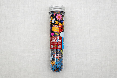 Load image 1 in gallery view. Clear tube containing colorful bee and flower puzzle 