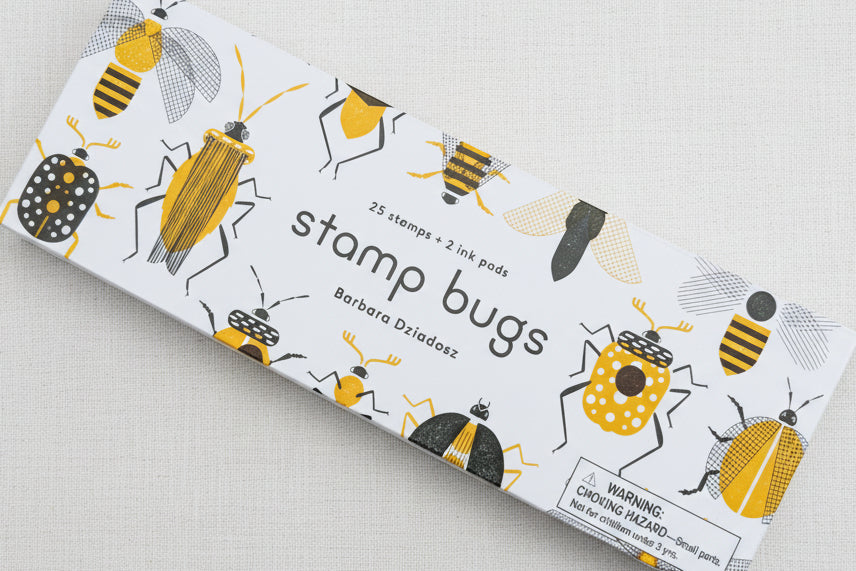 Box of bug-shaped stamps and ink pads 