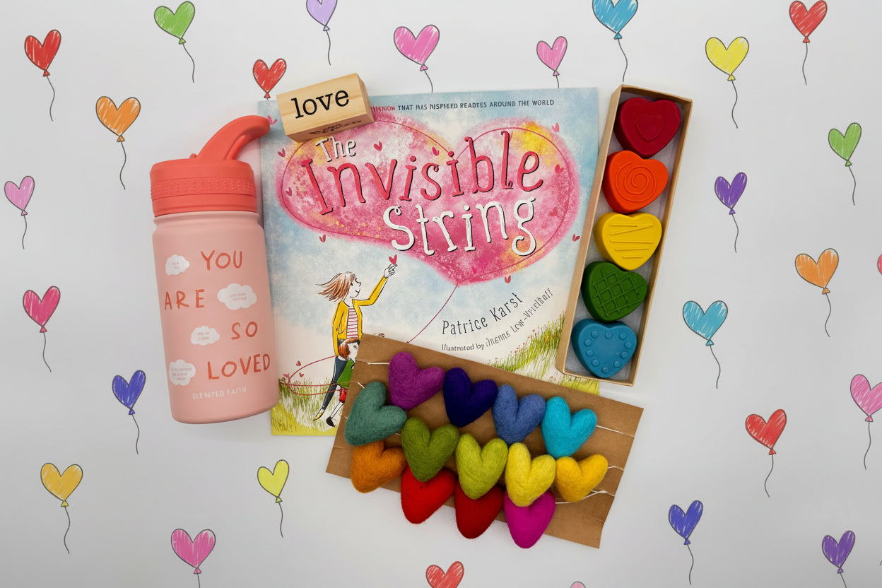 Book titled 'The Invisible String' with colorful heart-shaped string, crayons and a water bottle 