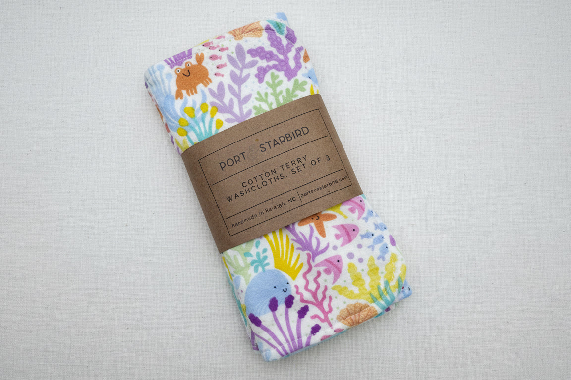 Set of three colorful cotton washcloths with marine animal pattern 